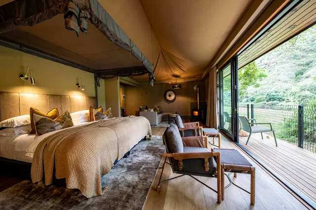 Luxury Tented Suite bedroom opening onto a deck, Botlierskop Tented Lodge