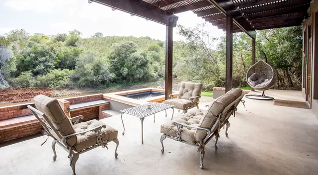 Covered outdoor stoep with plunge pool at a Botlierskop Bush Villa