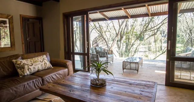 Bush Villa lounge opening onto a deck, Botlierskop