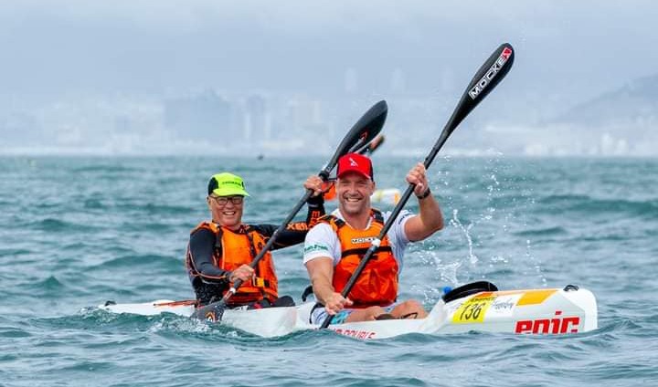 Smiling tandem surfski paddlers on the water off Cape Town