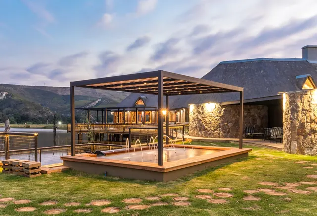 Spekbos Day Visitors Centre lit up at dusk, Botlierskop
